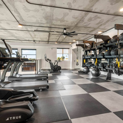 spacious gym with a variety of workout equipment